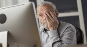 man looking at computer monitor